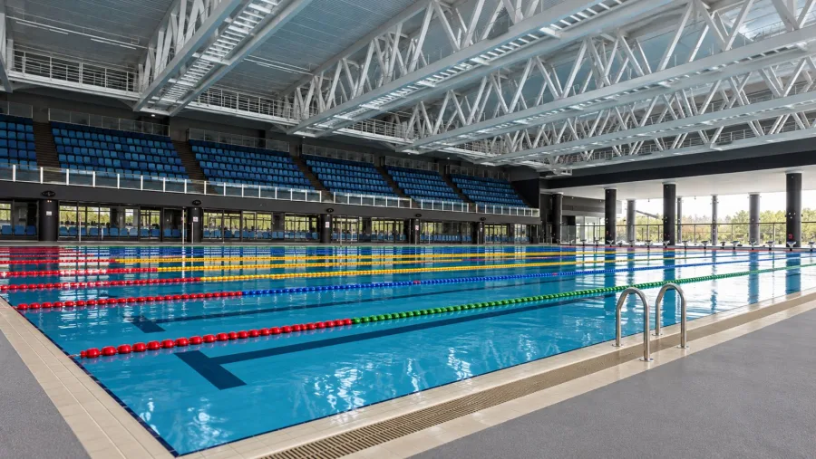 AI-generated impression of an indoor competition swimming pool with grandstand seating and pool ladders at Punggol Swimming Complex